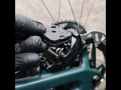 ZINE step-by-step guide inserting the aligner block into the brake caliper for precise brake pad centering.